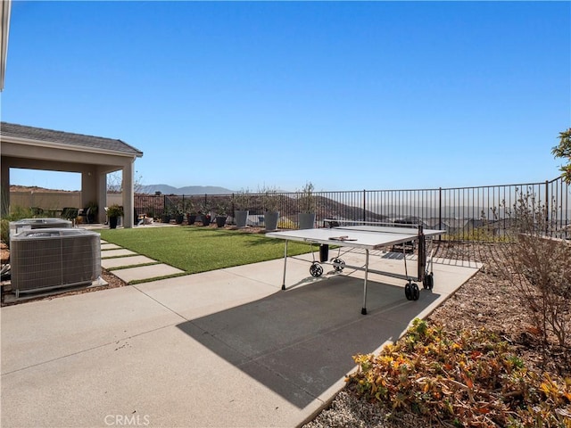 view of patio with a mountain view and central AC