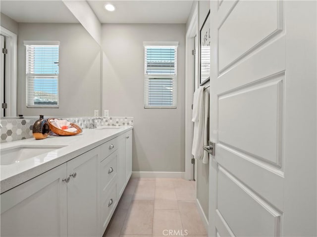 bathroom featuring vanity, tile patterned floors, and backsplash