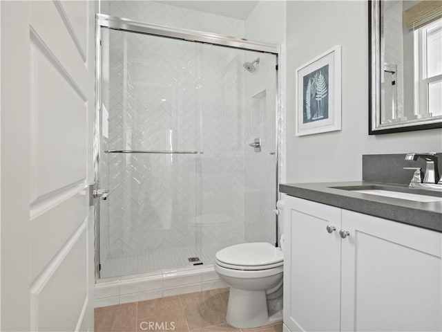 bathroom with vanity, toilet, and an enclosed shower