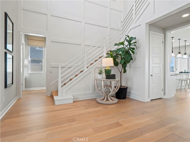 staircase with hardwood / wood-style floors and a wealth of natural light