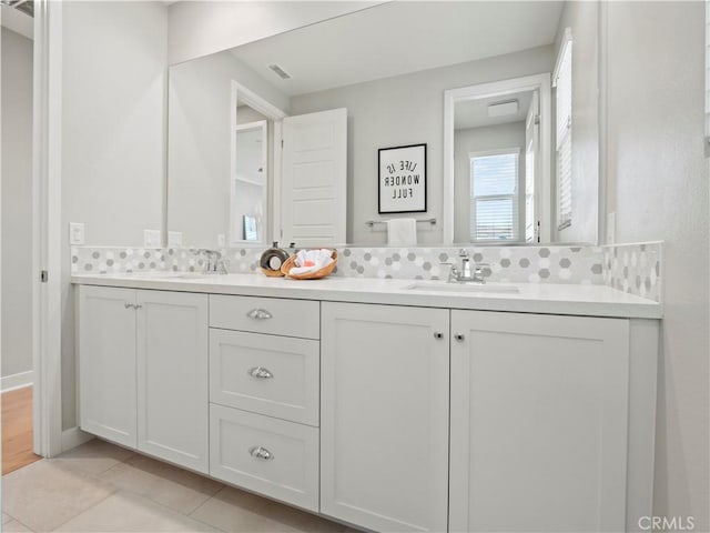 bathroom with vanity, tile patterned flooring, and decorative backsplash