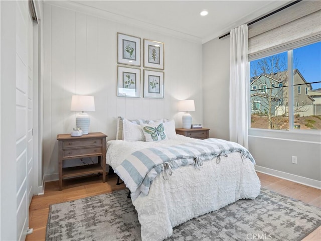 bedroom with wood-type flooring and crown molding