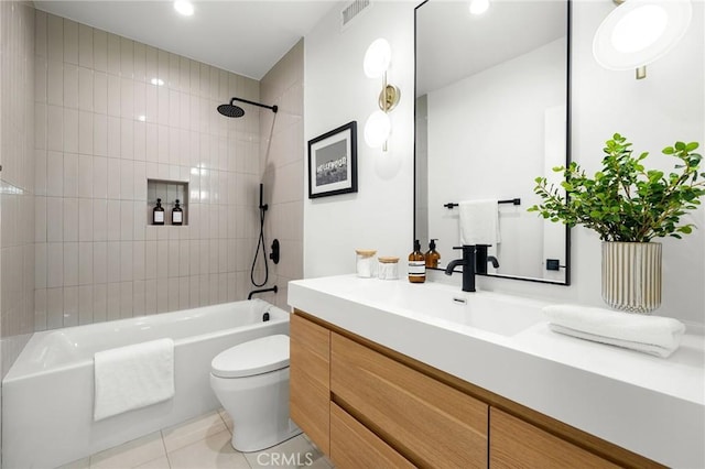 full bathroom featuring vanity, toilet, tiled shower / bath combo, and tile patterned flooring