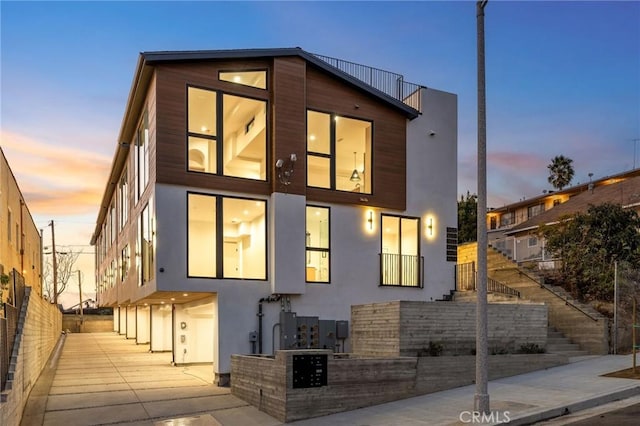 property exterior at dusk featuring a garage