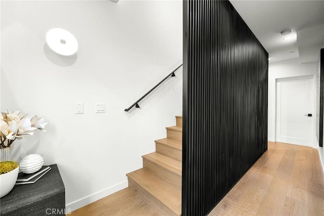 staircase featuring wood-type flooring