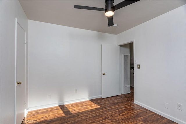 unfurnished room featuring ceiling fan and dark hardwood / wood-style flooring