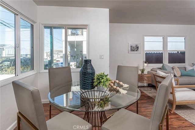 dining area featuring hardwood / wood-style flooring and a healthy amount of sunlight