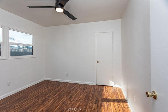 unfurnished room featuring ceiling fan and dark hardwood / wood-style flooring