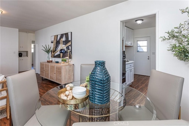 dining space featuring dark wood-type flooring