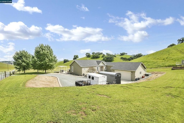 rear view of property with a yard and a rural view