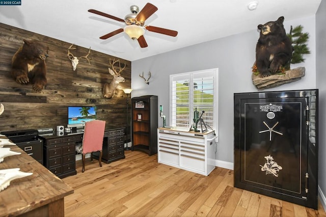 office area featuring ceiling fan, wooden walls, and light hardwood / wood-style floors