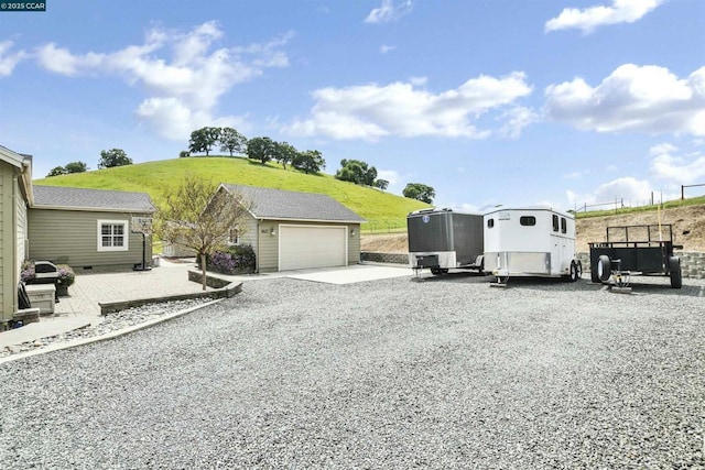 exterior space featuring a garage and an outdoor structure