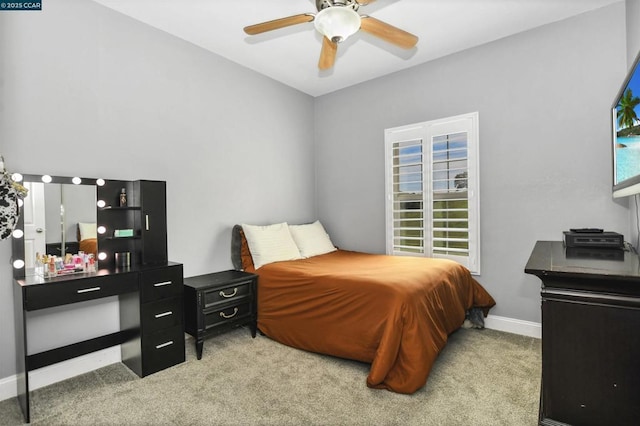 bedroom featuring light carpet and ceiling fan