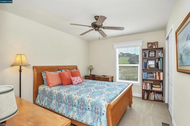 carpeted bedroom with ceiling fan