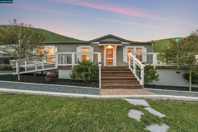 view of front of property with a yard and a deck