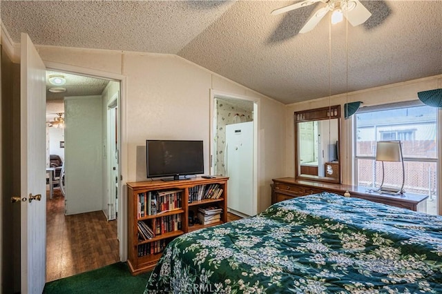 bedroom with dark hardwood / wood-style flooring, ceiling fan, vaulted ceiling, and a textured ceiling