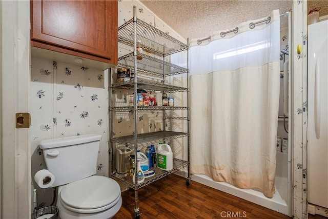 bathroom with toilet, hardwood / wood-style floors, and a textured ceiling