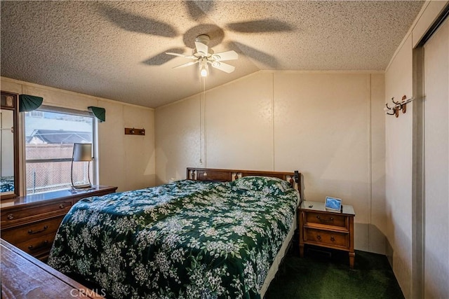 bedroom featuring ceiling fan, lofted ceiling, a textured ceiling, and dark carpet