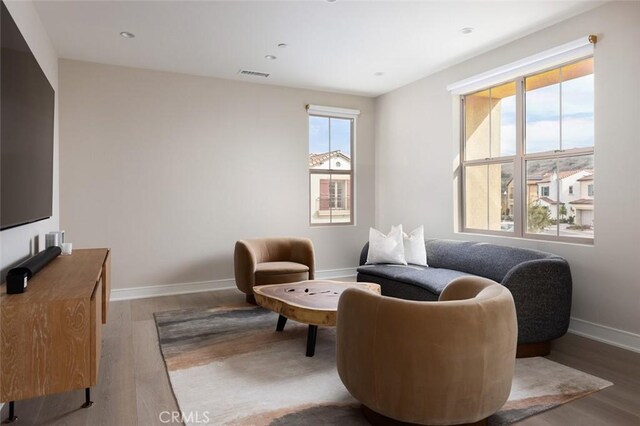 sitting room with hardwood / wood-style flooring