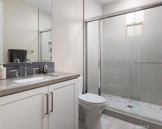 bathroom with vanity, an enclosed shower, and toilet