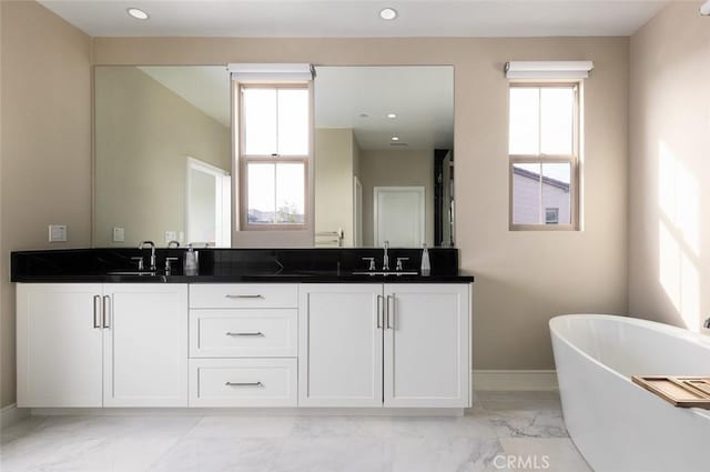 bathroom with vanity and a bathing tub