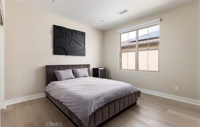 bedroom with hardwood / wood-style flooring