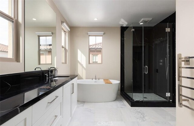 bathroom featuring vanity and separate shower and tub