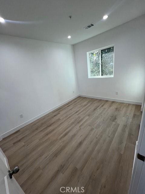 unfurnished room with light hardwood / wood-style floors