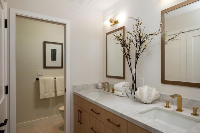 bathroom featuring tile patterned flooring, vanity, and toilet