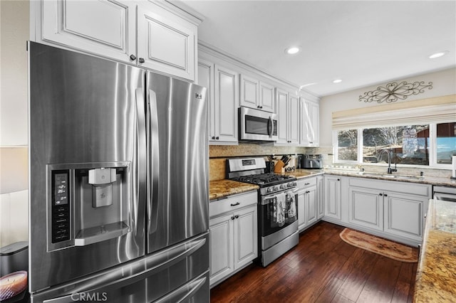 1430 Sequoia Dr, Lake Arrowhead, CA 92352 - kitchen with appliances with stainless steel finishes, dark wood-style flooring, tasteful backsplash, white cabinets, and light stone counters