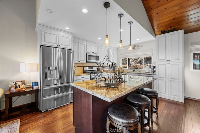 1430 Sequoia Dr, Lake Arrowhead, CA 92352 - kitchen with stainless steel appliances, light stone counters, dark wood-type flooring, white cabinets, and lofted ceiling