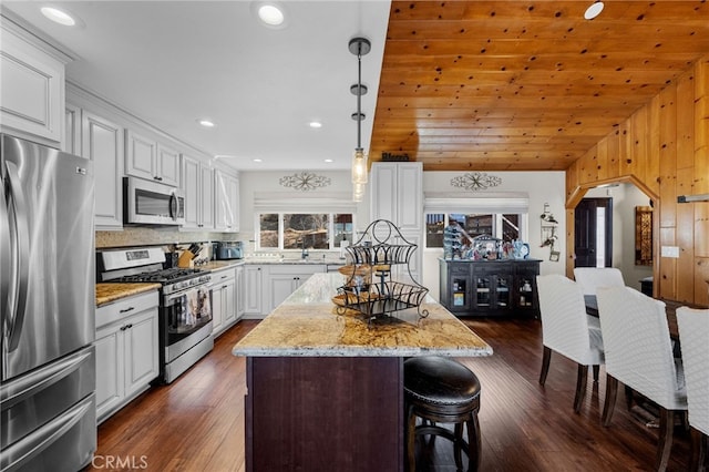 1430 Sequoia Dr, Lake Arrowhead, CA 92352 - kitchen featuring appliances with stainless steel finishes, a breakfast bar area, a kitchen island, white cabinetry, and recessed lighting