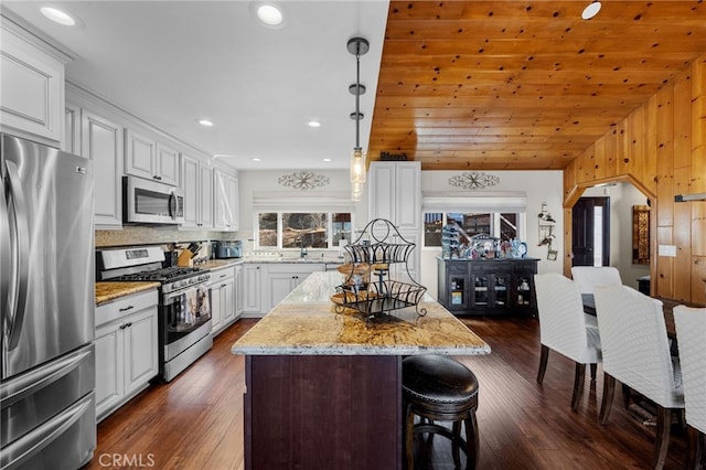 1430 Sequoia Dr, Lake Arrowhead, CA 92352 - kitchen with stainless steel appliances, a kitchen bar, a center island, white cabinetry, and recessed lighting