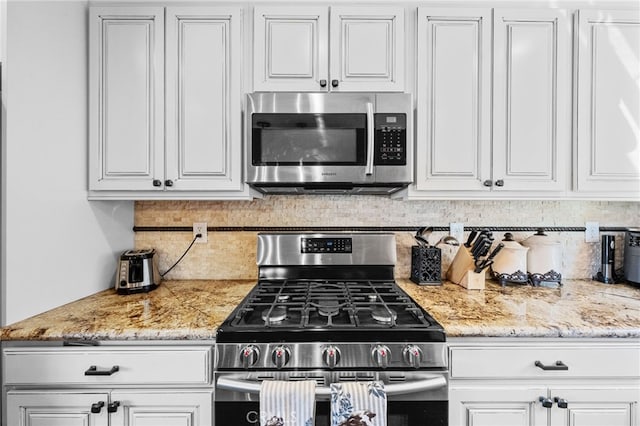 1430 Sequoia Dr, Lake Arrowhead, CA 92352 - kitchen featuring stainless steel appliances, white cabinetry, tasteful backsplash, and light stone counters