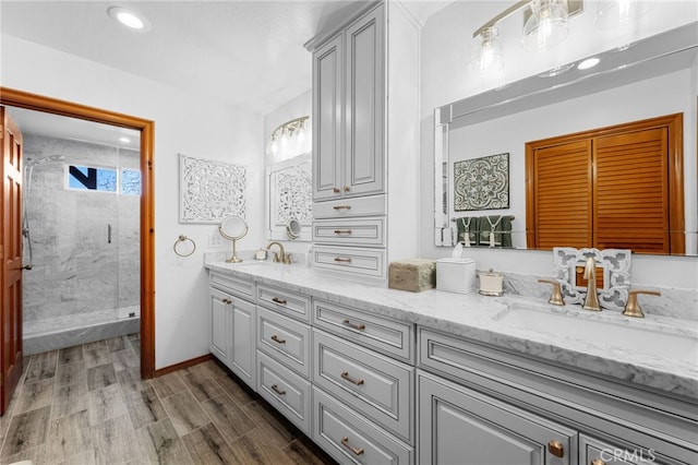 1430 Sequoia Dr, Lake Arrowhead, CA 92352 - full bathroom featuring double vanity, a stall shower, wood finished floors, and recessed lighting