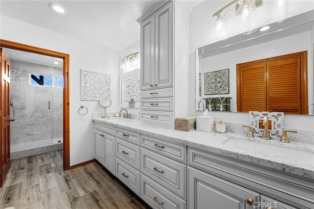 1430 Sequoia Dr, Lake Arrowhead, CA 92352 - bathroom featuring double vanity, a stall shower, wood finished floors, and recessed lighting