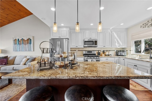1430 Sequoia Dr, Lake Arrowhead, CA 92352 - kitchen featuring stainless steel appliances, a kitchen breakfast bar, white cabinets, dark wood-type flooring, and recessed lighting