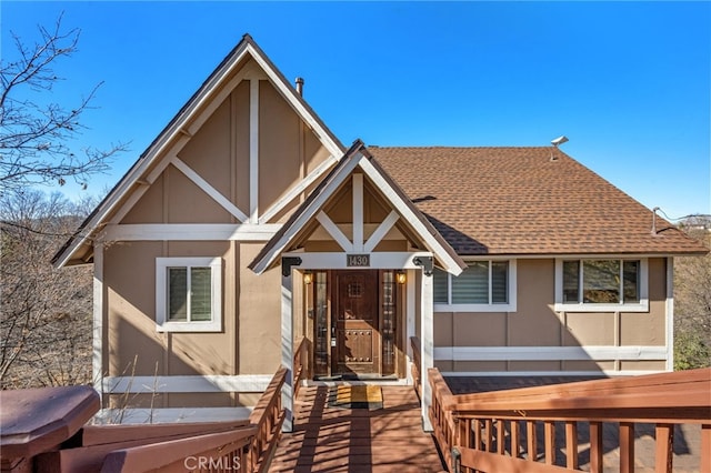 view of front of house with stucco siding and roof with shingles