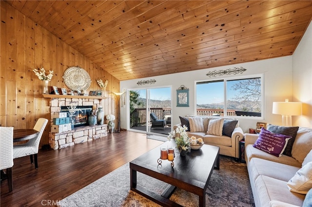 1430 Sequoia Dr, Lake Arrowhead, CA 92352 - living area featuring vaulted ceiling, wood finished floors, a stone fireplace, wooden walls, and wooden ceiling
