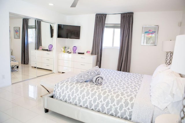 tiled bedroom featuring a closet and ceiling fan