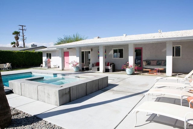 view of pool with outdoor lounge area, a patio, and an in ground hot tub