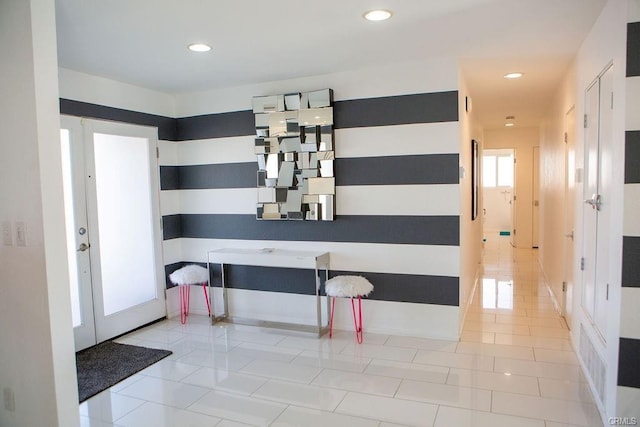 corridor with french doors and light tile patterned floors