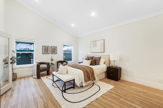 bedroom featuring crown molding, high vaulted ceiling, and light wood-type flooring