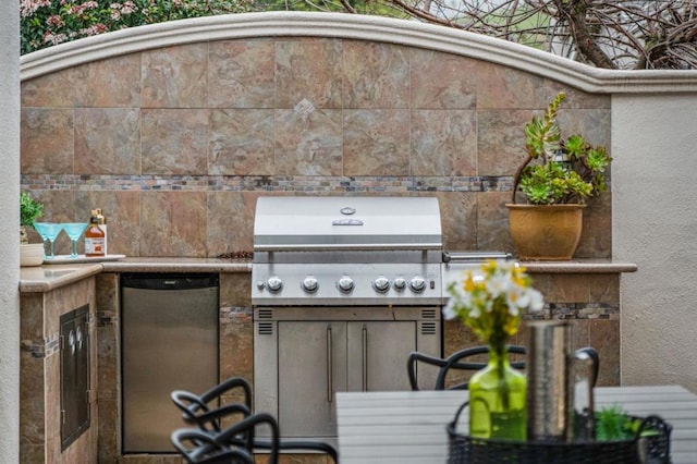 view of patio with area for grilling and a grill