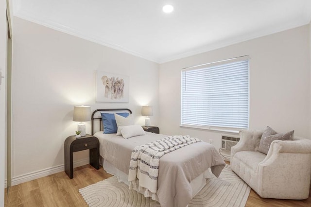 bedroom with ornamental molding and light wood-type flooring