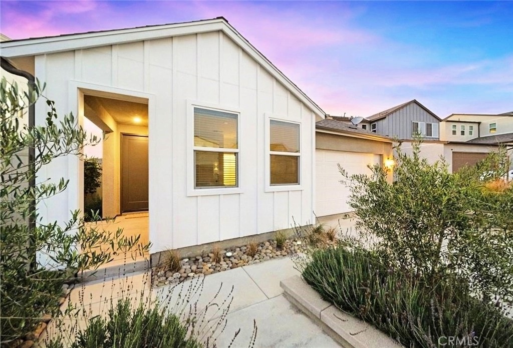 property exterior at dusk with a garage