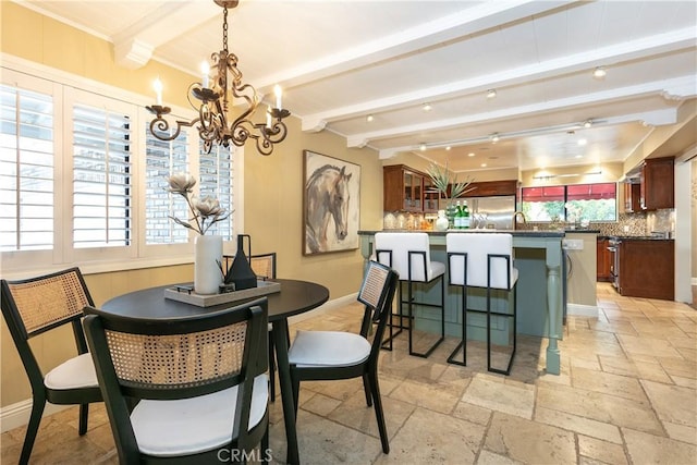 dining room with beamed ceiling and a chandelier