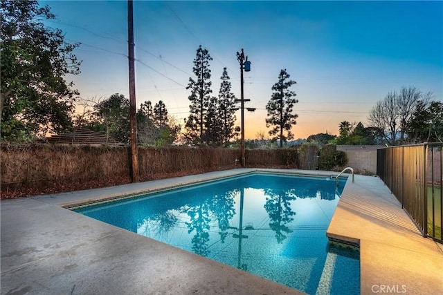 view of pool at dusk