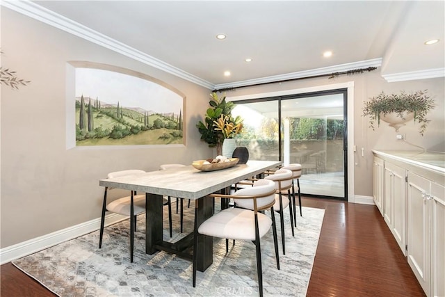 dining space with ornamental molding and dark hardwood / wood-style flooring