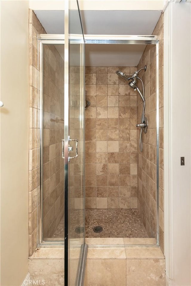 bathroom featuring a shower with shower door